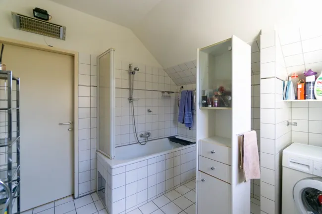 Badezimmer mit Wanne und Waschmaschinenanschluss